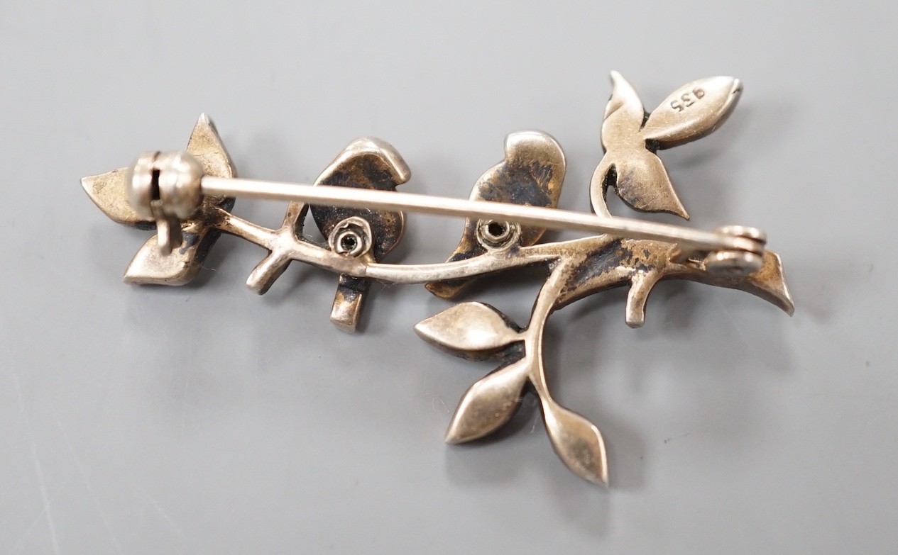 An early 20th century, yellow and white metal, turquois and marcasite set bar brooch, modelled as two birds on a branch, 39mm.